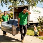 Movers carrying sofa in Perth suburban home